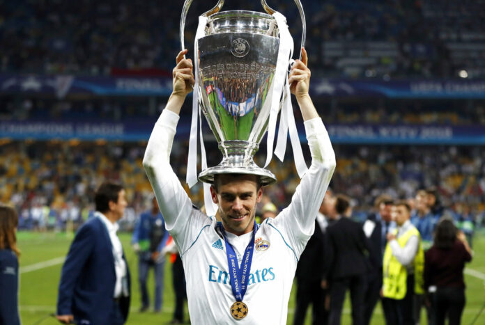 Real Madrid's Gareth Bale celebrates with the trophy after winning the Champions League Final soccer match between Real Madrid and Liverpool on Saturday at the Olimpiyskiy Stadium in Kiev, Ukraine. Photo: Pavel Golovkin / Associated Press