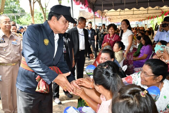 Junta chairman Prayuth Chan-ocha on Monday shakes hands with Surin province residents.