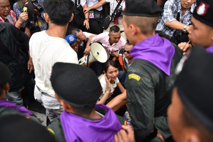 Police move in to arrest activist leader Chonticha Chaengrew and other protesters.