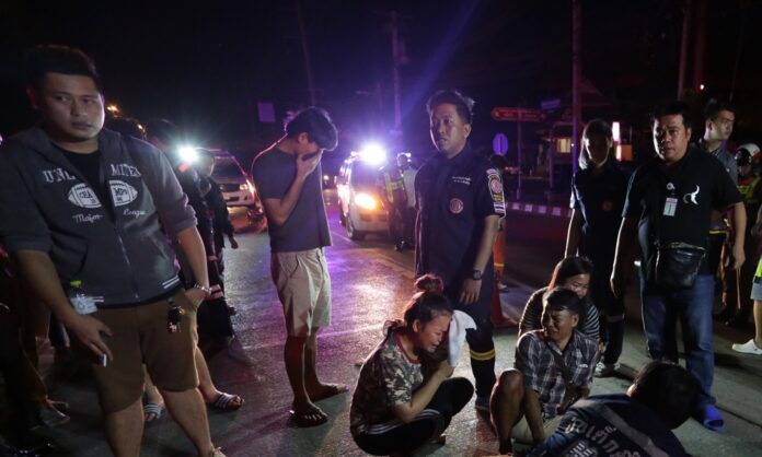 Police and rescue workers Friday attend to someone hit and killed by a van driver who fled the scene in Bangkok.