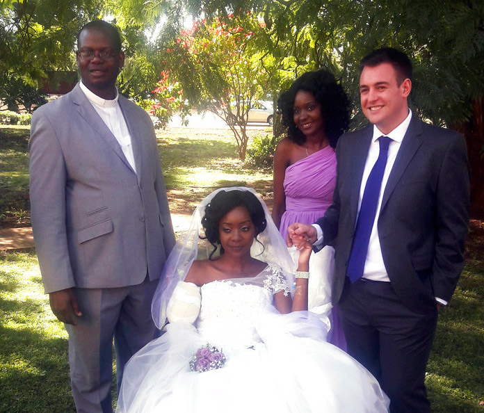 Zenele Ndlovu, at center, and Jamie Fox hold hands on their wedding day Saturday at a hospital Chapel in Bulawayo, Zimbabwe, five days after they were attacked by a crocodile. Photo: Associated Press