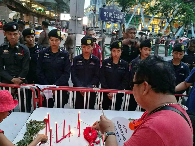 Police flank the site of Saturday's vigil at Ratchaprasong Intersection in Bangkok.