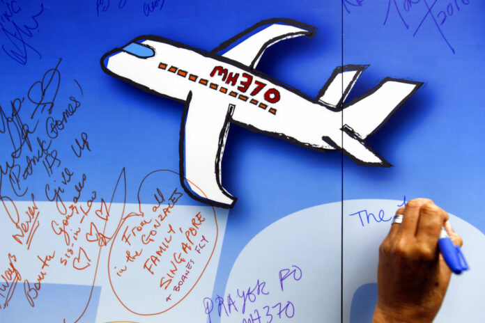 In this March 6, 2016, file photo, well wishes are written on a wall of hope during a remembrance event for the ill fated Malaysia Airlines Flight 370 in Kuala Lumpur, Malaysia. Photo: Joshua Paul / Associated Press