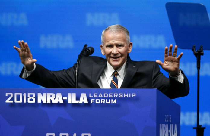 Former U.S. Marine Lt. Col. Oliver North acknowledges attendees as he gives the invocation Friday at the National Rifle Association-Institute for Legislative Action Leadership Forum in Dallas. Photo: Sue Ogrocki / Associated Press