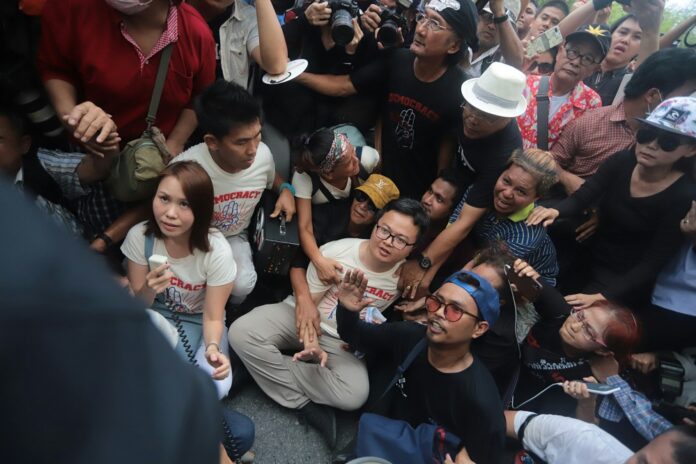 Police move in to arrest activist leader Nuttaa Mahattana and other protesters at Tuesday's rally.