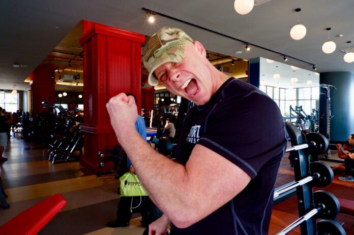 Sgt. Ken Weichert flexes his left bicep Friday in Bangkok.