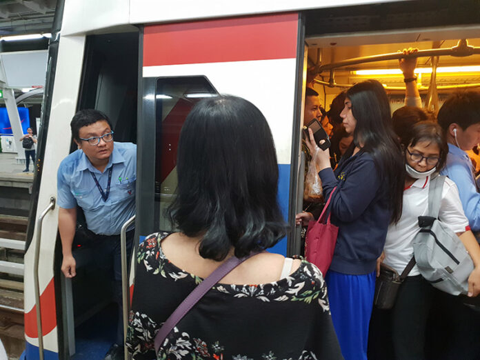 A BTS Skytrain engineer peeks outside the train during the disruption on June 22 at BTS Chit Lom.