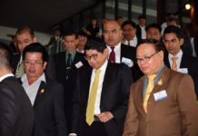 Elections May be Deferred to May: Deputy PM Deputy Prime Minister Wissanu Krue-ngam, center, emerges from a meeting with political parties in June in Bangkok, flanked by meeting participants.