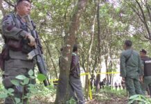 4 Villagers Shot Dead in Insurgency-Plagued South Armed soldiers stand guard at the scene of the Thursday shooting in Narathiwas province.