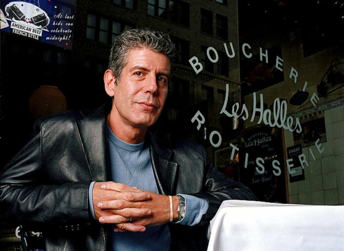 Anthony Bourdain, the owner and chef of Les Halles restaurant, sits at one of the tables in 2001 in New York. Photo: Jim Cooper / Associated Press