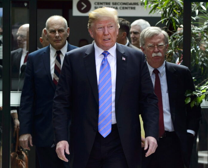 U.S. President Donald Trump in June leaves the G7 Leaders Summit in La Malbaie with White House Chief of Staff John Kelly, left, and National Security Adviser John Bolton. Photo: Sean Kilpatrick / Associated Press
