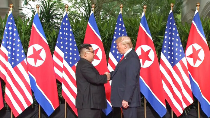 In this image made from video provided by Host Broadcaster Mediacorp Pte Ltd, U.S. President Donald Trump and North Korean leader Kim Jong Un shake hands ahead of their meeting Tuesday at Capella Hotel in Singapore. Image: Associated Press