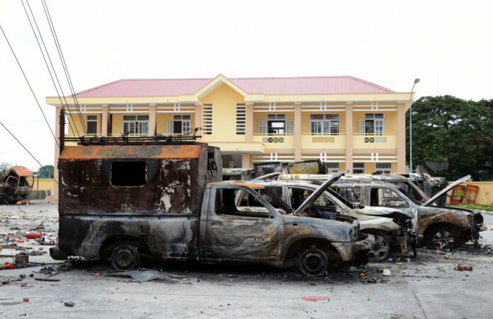 A row of charred vehicles is seen June 12 at the fire and police station in the south central province of Binh Thuan, Vietnam. Photo: Associated Press