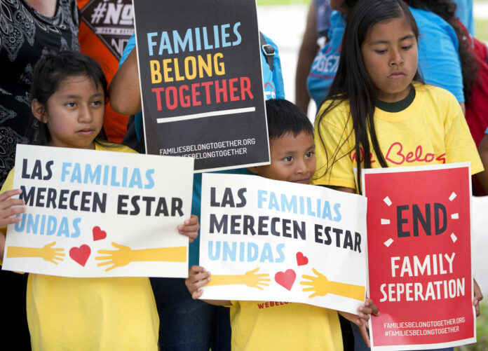 Children hold signs during a demonstration in front of the Immigration and Customs Enforcement offices in Miramar, Fla. Photo : Wilfredo Lee / Associated Press.