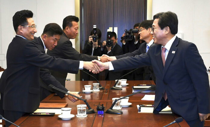 South Korean head delegate Jeon Choong-ryul, right, shakes hands with his North Korean counterpart Won Kil U during a meeting at the southern side of Panmunjom in the Demilitarized Zone, North Korea, Monday, June 18, 2018. Photo South Korea Culture And Sports Ministry/ Associated Press.