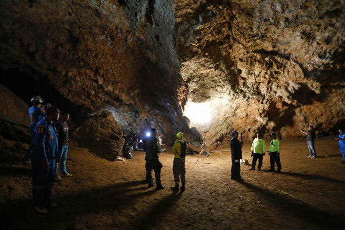Rescue teams gather Monday in a deep cave where a group of boys went missing in Chang Rai. Photo: Krit Promsakla Na Sakolnakorn / Thai News Pix / AP