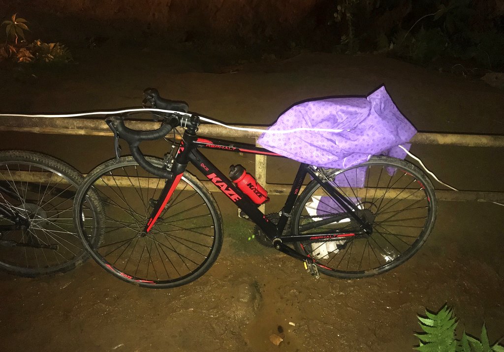A bicycle left by one of the missing boys stands parked outside a flooded cave Tuesday. Photo: Tassanee Vejpongsa / Associated Press