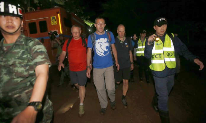 The British Cave Rescue Council members from second left, Robert Charles Harper , John Volanthen and Richard William on Wednesday arrive at cave in the staging area as they continue the search for a young soccer team and their coach believed to be missing in a large cave. Photo / Sakchai Lalit / Associated Press