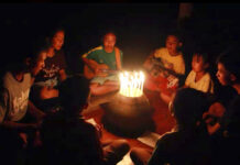 In Song and Prayer, Thais Show Solidarity With Missing Boys In this image from video made available on Friday, June 29, 2018, a group of young children sit around candles and play a song at a school in Buriram, eastern Thailand, in support for the missing soccer team and their coach in a flooded cave in the north. Photo: Lek Nai Tung Kwang school via AP