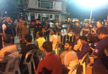 Germans, Russians Netted in This Week’s ‘X-Ray’ Foreigner Raids Maj. Gen. Surachet ‘Big Joke’ Hakpan, standing in brown, addresses a group of foreign detainees outside the Montien Hotel in Bangkok’s Bang Rak district.