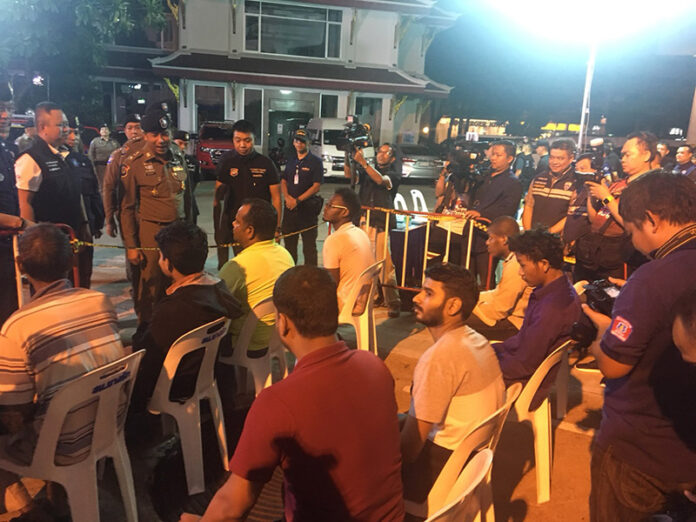 Maj. Gen. Surachet ‘Big Joke’ Hakpan, standing in brown, addresses a group of foreign detainees outside the Montien Hotel in Bangkok’s Bang Rak district.