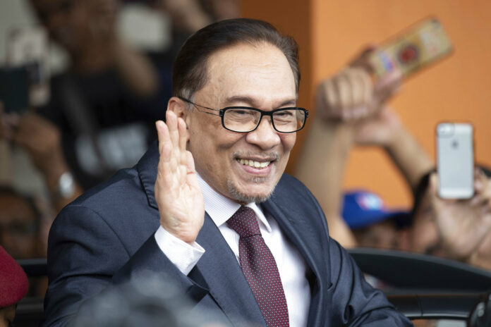 Prominent Malaysian politicin Anwar Ibrahim waves to supporters as he leaves a hospital Saturday in Kuala Lumpur. Photo: Vincent Thian / Associated Press Prominent Malaysian politicin Anwar Ibrahim waves to supporters as he leaves a hospital Saturday in Kuala Lumpur. Photo: Vincent Thian / Associated Press