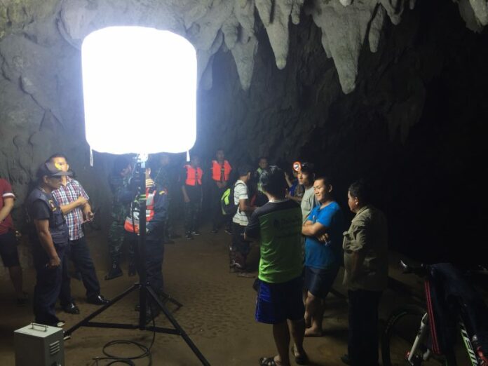 A search party Sunday in a cave in Chiang Rai province.