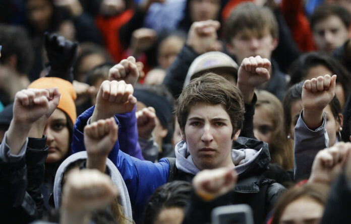 Demonstrators raise their fists in the air during a student-led march in March against gun violence at the Civic Center Plaza in San Francisco, one month after the deadly shooting inside a high school Florida. Photo: Marcio Jose Sanchez / Associated Press