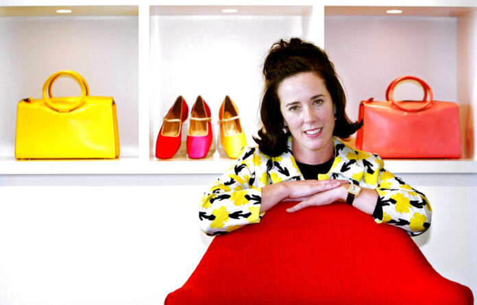 Designer Kate Spade poses with handbags and shoes from her next collection in 2004 in New York. Photo: Bebeto Matthews / Associated Press