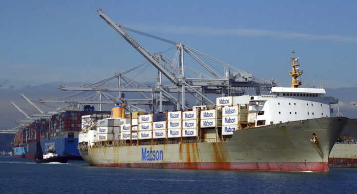 A tugboat assists a container ship in docking at the Port of Oakland in March 2018 in Oakland, California. Photo: Ben Margot / Associated Press
