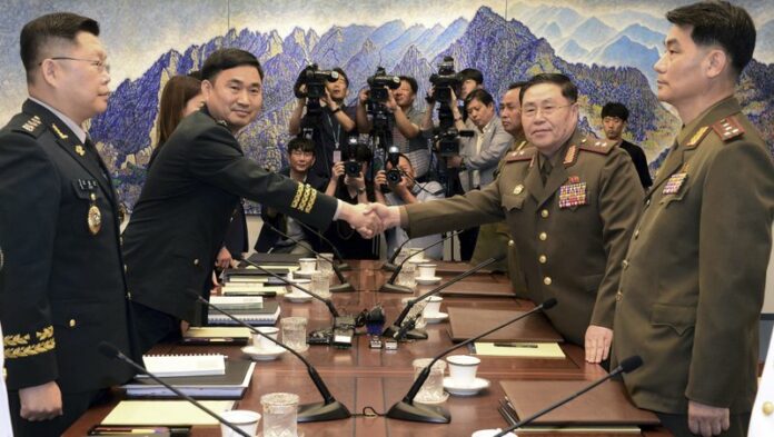 North Korean Lt. Gen. An Ik San, second from right, on Tuesday shakes hands with his South Korean counterpart Maj. Gen. Kim Do-gyun during a meeting inside the Peace House at the border village of Panmunjom, South Korea. Photo: Korea Pool / Yonhap via Associated Press