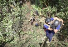 Alternate Cave Entries Sought as Suffocation Risk Grows Border patrol police on Friday morning descend by rope from a helicopter onto a hill above the cave.