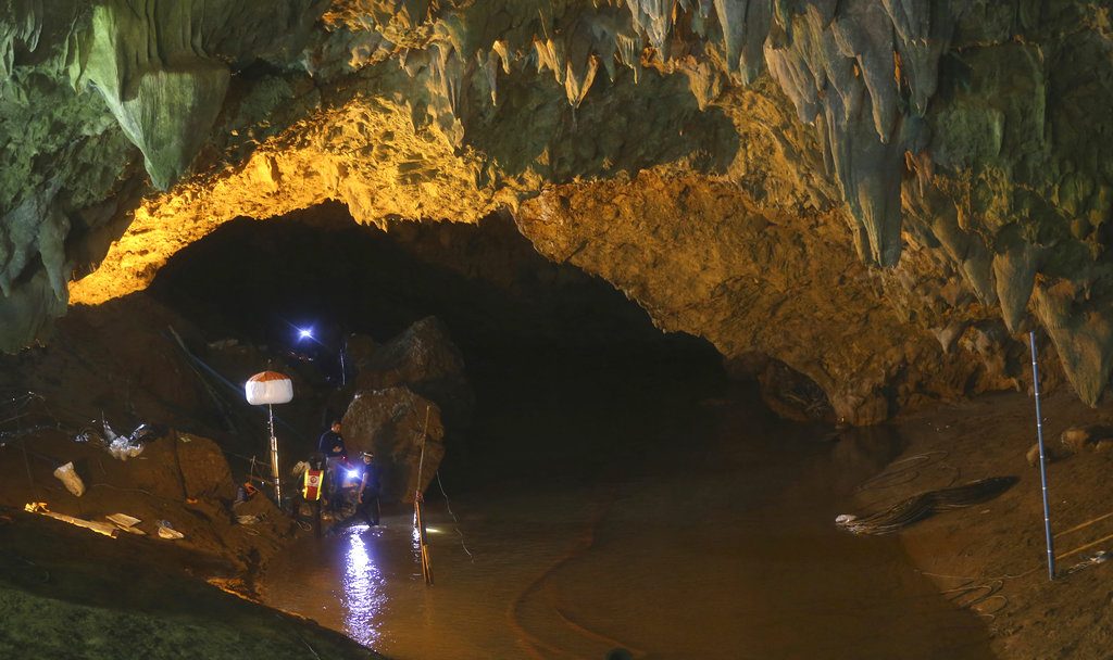 Rescuers talk each other during a July 1 search operation at the entrance to a cave complex where 12 soccer team members and their coach went missing, in Mae Sai, Chiang Rai province. Photo: Sakchai Lalit / Associated Press