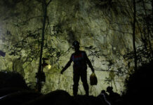 Rescuers Clear Hurdle in Cave Search for Missing Boys Rescuers Sunday make their way down at the entrance to a cave complex where 12 boys and their soccer coach went missing, in Mae Sai, Chiang Rai province. Photo: Sakchai Lalit / Associated Press