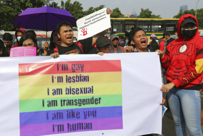 LGBT activists shout slogans Feb. 12, 2018, during a rally against a planned revision to Indonesia's criminal code that would criminalize unmarried and gay sex outside the Parliament in Jakarta, Indonesia. Photo: Tatan Syuflana/ Associated Press File