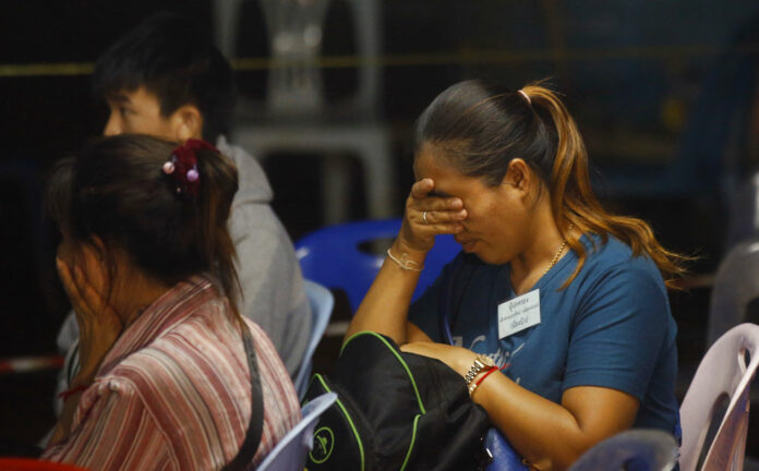 Family members of the 12 boys and their soccer coach on Tuesday react after they were found alive, in Mae Sai, Chiang Rai. Photo: Sakchai Lalit / Associated Press