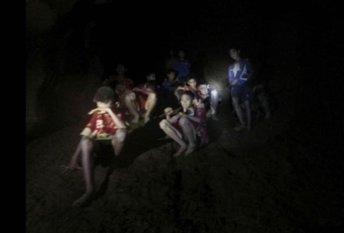 A photo released by Tham Luang Rescue Operation Center on Monday shows the boys and their soccer coach as they were found in a partially flooded cave, in Mae Sai, Chiang Rai. Photo: Tham Luang Rescue Operation Center via Associated Press