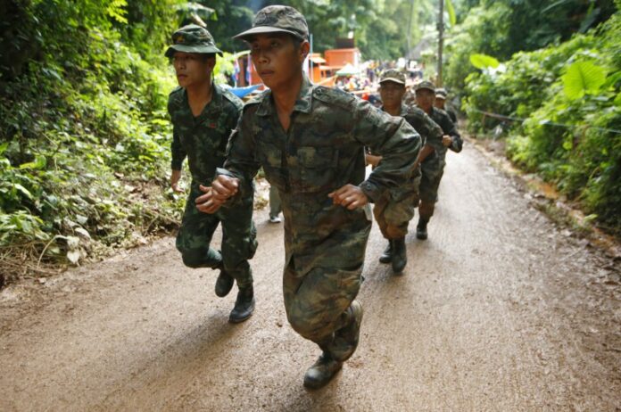 Thai soldiers make their way up at the entrance to a cave complex where 12 boys and their soccer coach has been trapped, in Mae Sai, Chiang Rai. Photo: Sakchai Lalit / Associated Press