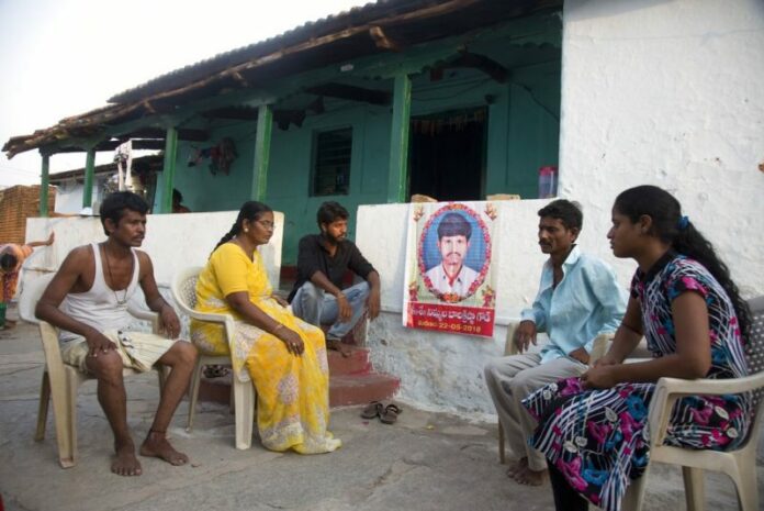 FILE - In this May 25, 2018 file photo, family member grieve by a portrait of Bala Krishna, a 33-year-old motorized rickshaw driver who was killed by a mob inflamed by social media in Jiyapalli village, outside his house at Korremula village, on the outskirts of Hyderabad, India. Photo: Mahesh Kumar A. / Associated Press
