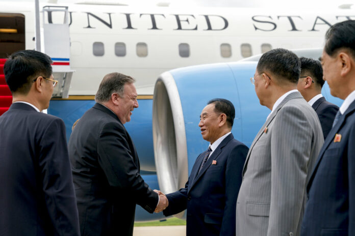 U.S. Secretary of State Mike Pompeo, second from left, is greeted by North Korean Director of the United Front Department Kim Yong Chol as he arrives at Sunan International Airport on Friday in Pyongyang, North Korea. Photo: Andrew Harnik / Associated Press