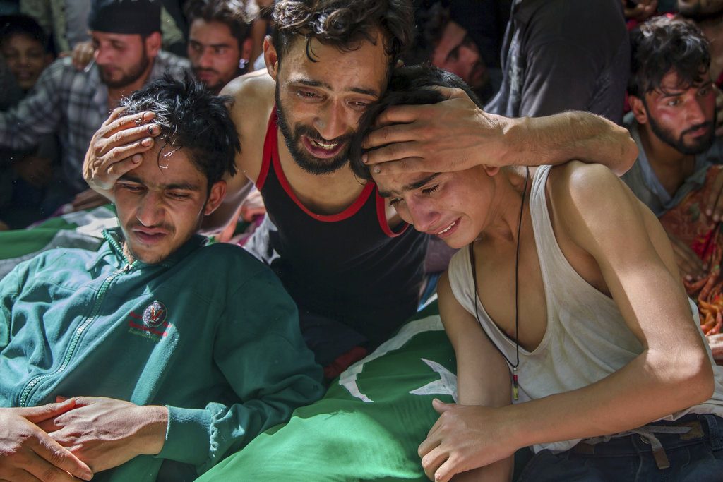 Relatives of Kashmiri civilians grieve near their dead bodies Saturday during a joint funeral procession in Hawoorah village, some 68 kilometers (42 miles) south of Srinagar, Indian controlled Kashmir. Photo: Dar Yasin / Associated Press