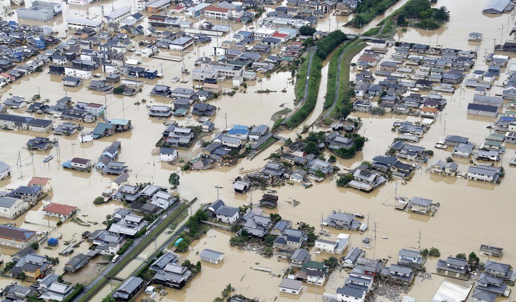 Houses are submerged by muddy water Sunday following heavy rain in Kurashiki city, Okayama prefecture, southwestern Japan. Photo: Shohei Miyano / Associated Press