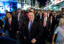 Pompeo Points to Vietnam as Example of Improved Relations Secretary of State Mike Pompeo, center, walks on Sunday through the streets of Hanoi, Vietnam. Photo: Andrew Harnik / Associated Press
