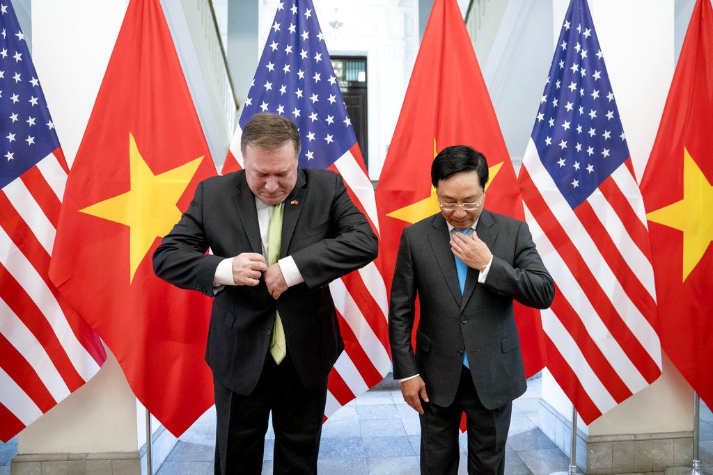 U.S. Secretary of State Mike Pompeo, left, and Vietnamese Deputy Prime Minister and Foreign Minister Pham Binh Minh arrive for photos Monday before a meeting at the Ministry of Foreign Affairs in Hanoi, Vietnam. Photo: Andrew Harnik / Associated Press