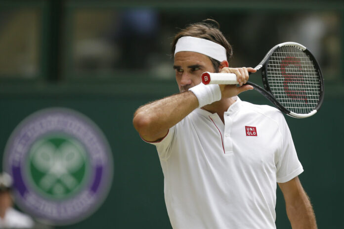 Roger Federer of Switzerland wipes his face during his men's singles match against France's Adrian Mannarino, on day seven of the Wimbledon Tennis Championships on Monday in London. Photo: Tim Ireland / Associated Press