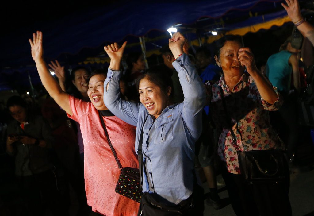 People celebrate Tuesday after divers evacuate some of the 12 boys and their coach trapped at Tham Luang cave in the Mae Sai district of Chiang Rai province. Photo: Sakchai Lalit / Associated Press
