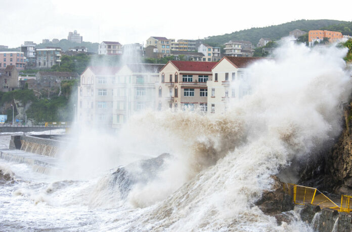 Large waves crash against the shoreline Tuesday as Typhoon Maria approaches in Wenling city in eastern China's Zhejiang Province. Photo: Zhu Haiwei / Associated Press