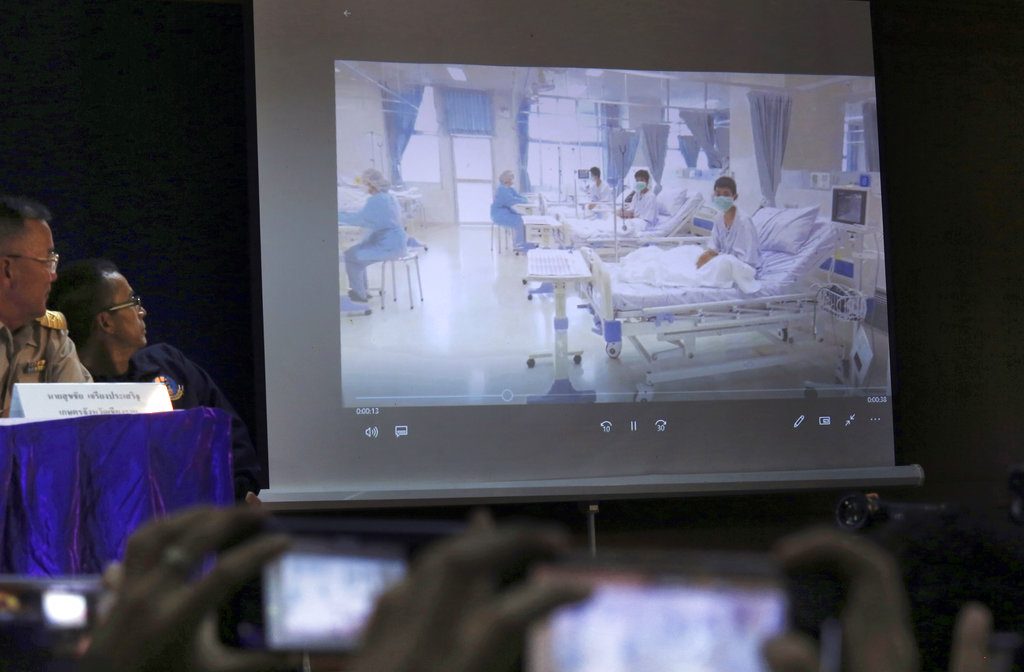 A projected image of the rescued boys in their hospital room is shown during a police press conference Wednesday in Chiang Rai province. Photo: Associated Press