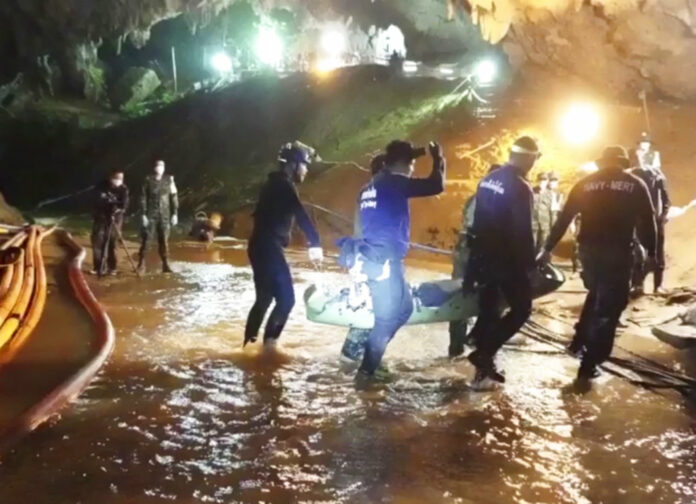 In this undated file image from video released July 11, rescuers hold an evacuated boy inside the Tham Luang Nang Non cave in Mae Sai, Chiang Rai province. Photo: Associated Press