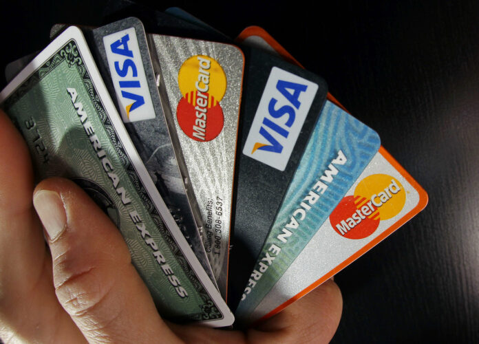 In this March 5, 2012 file photo, consumer credit cards are posed in North Andover, Massachusetts. Photo: Elise Amendola / Associated Press